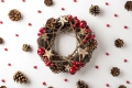 top-view-photo-christmas-twig-wreath-scattered-holly-berries-pine-cones-isolated-white-background.jpg
